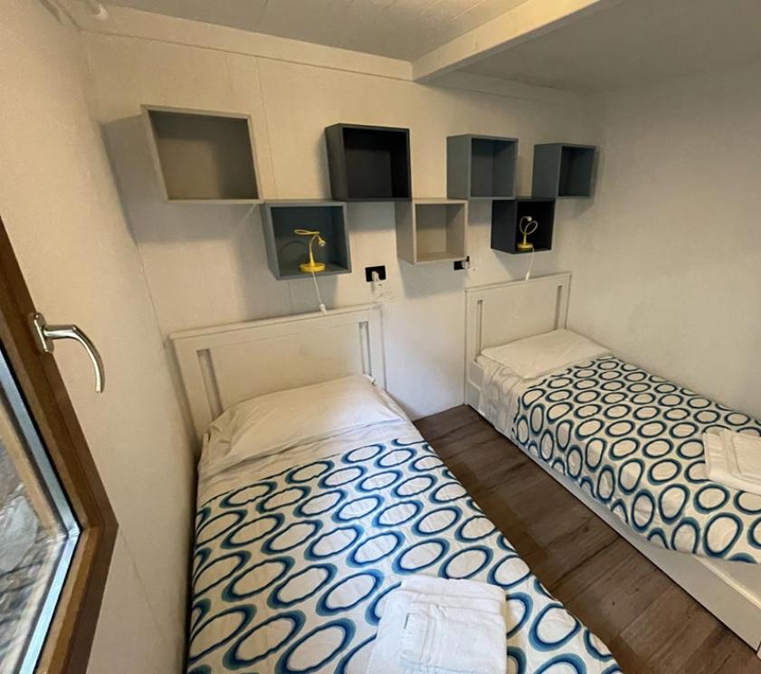 Chambre avec deux lits simples, décoration simple et moderne.