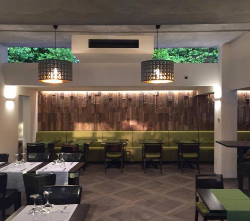 Modern restaurant with soft lighting and decorative wooden walls.
